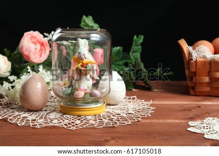 Easter decoration with eggs, flowers and bunny on Wooden background. Happy Easter! card concept