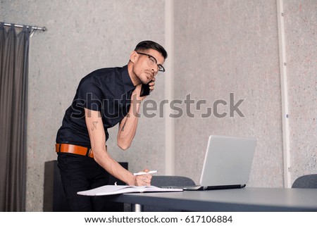 Businessman in office answering the phone,office