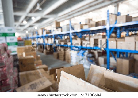 Supermarket warehouses inside, high shelves with cartons and goods