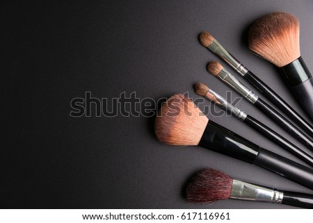 Set of flat top view of various professional female cosmetics brushes for makeup and eyelash brush isolated on black background, Cosmetics concept, Make up concept, Copy space image for your text. Royalty-Free Stock Photo #617116961