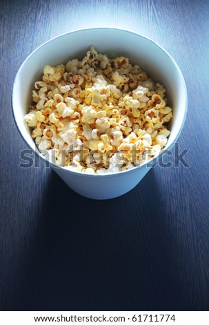 Popcorn bucket in front of TV light
