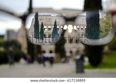 The view of the Roman Coliseum through the glasses, at sunset, Rome, Italy