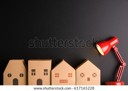 Paper house and Red lamp isolated on black background with copy space image for your text.Real estate concept, New house concept, Finance loan business concept Royalty-Free Stock Photo #617165228