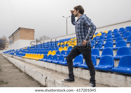 A photographer takes pictures at the stadium. No people