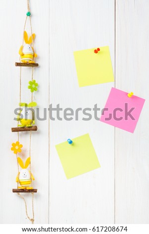 Egg Decoration Easter Bunny on white wooden background with yellow and pink sticker notes.