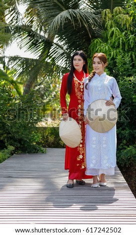 thai models in vietnamese dress in white and red smile beautiful