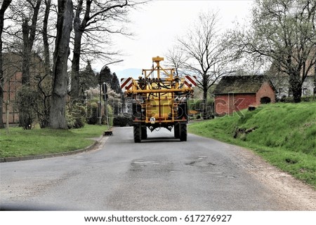 An image of a tractor on the road