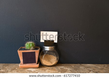 small cactus vase and a tiny brown sugar bottle for decoration with blank paper space for some text.