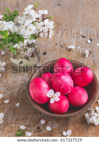 Easter still life on wooden background. Hand painted red easter eggs and apple tree blossom flowers on rustic wooden table fine art. Traditional easter holiday celebration concept. Vertical