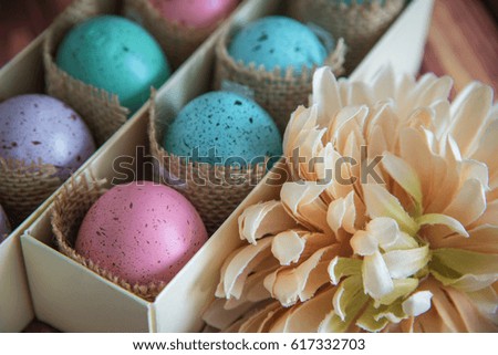 assorted colorful painted Easter eggs in a gift box on wooden background