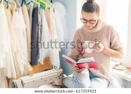 Dressmaker choosing trendy violet color for new collection of clothes