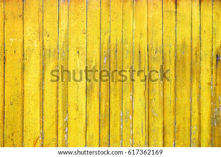 Texture of old wooden fence painted in yellow