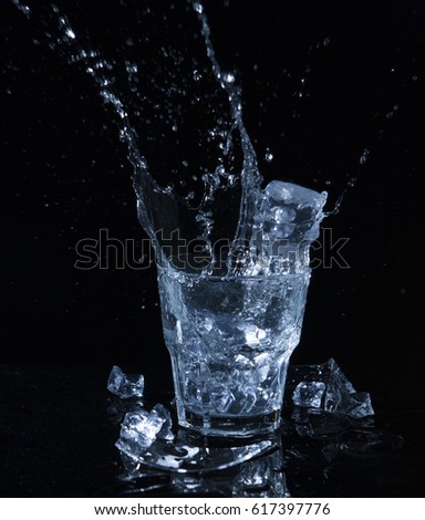 Water splash with drops from a glass
