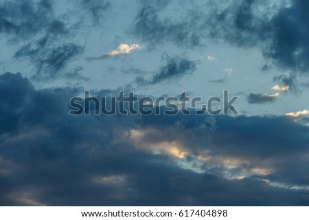 Dramatic blue evening sunset sky with stormy clouds