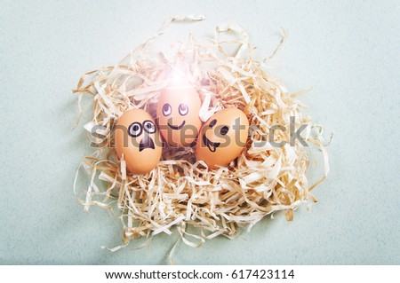 Funny Easter eggs with drawn faces depicting various emotions lying in nest