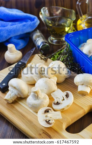Fresh mushrooms champignons on the kitchen board
