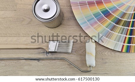 Paint bucket with paint brush, roller, palette color and paint can