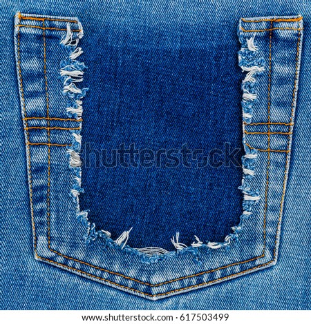  Destroyed torn denim blue jeans pocket frame. Ripped back denim pocket background. Close up blue jean texture
