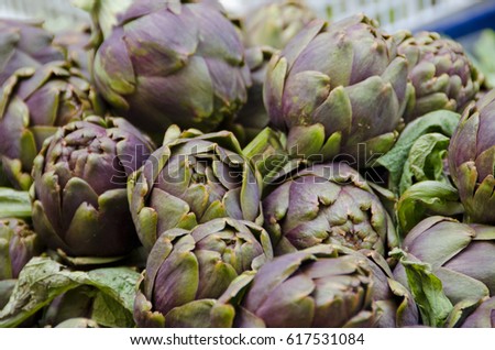 San Gimignano started as an Etruscan hilltop town. Pictured here are organic artichokes offered for sale at the local farmer's market in Piazza della Erbe. Focus is on the artichokes in the middle.
