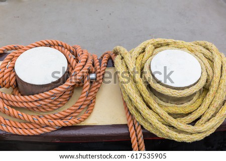 picture of bollards with mooring ropes at a harbor