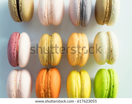 Colorful macarons line-up on white backgound, selective focus
