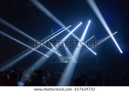 Light show and Dancing party crowd people enjoying . DJ in clubs that have Music fun. Blurry night club DJ party people enjoy of music dancing sound . Bangkok RCA Thailand.