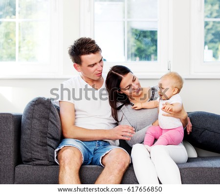 Happy couple with baby child.