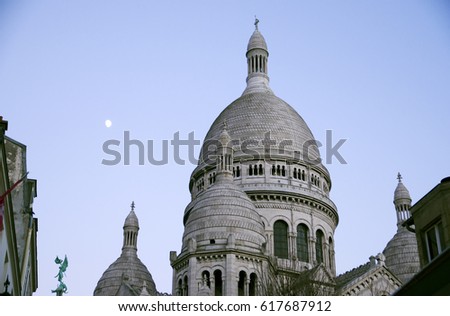 The Montmartre Sacre Coeur Basilica at the dawn of the crescent moon, Paris France