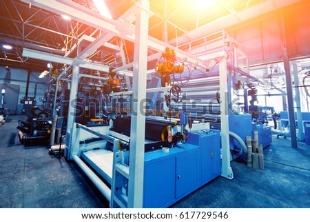 Automated production line in factory. Plastic bag manufacturing process Royalty-Free Stock Photo #617729546