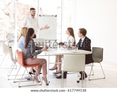 Business trainer giving presentation to group of people Royalty-Free Stock Photo #617749538