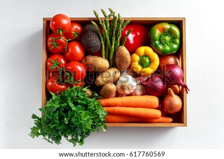 Fresh Vegetables in wooden box on white wooden background Royalty-Free Stock Photo #617760569