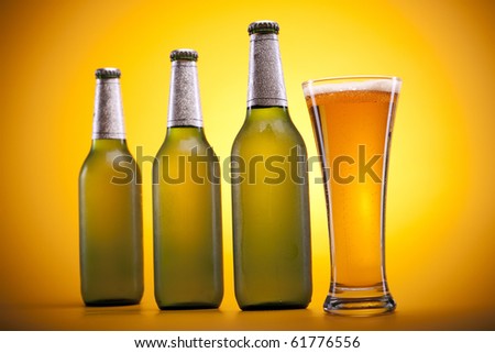 Chilled beer on yellow background