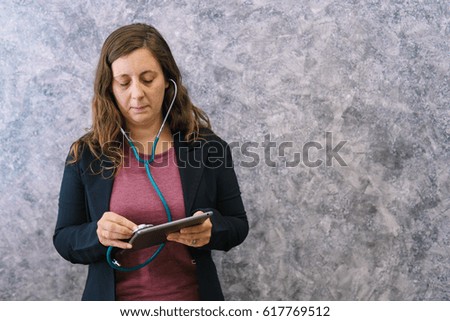 Headphones and medical heart Businesswoman inspects financial image