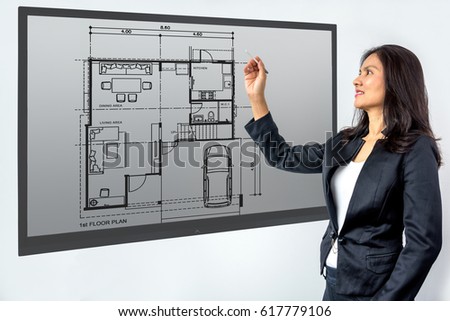 Businesswoman (Architect / Interior designer) working with modern futuristic virtual layout home / Future technology concept