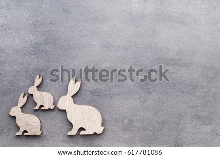 Handmade wood easter rabbits on wooden background.