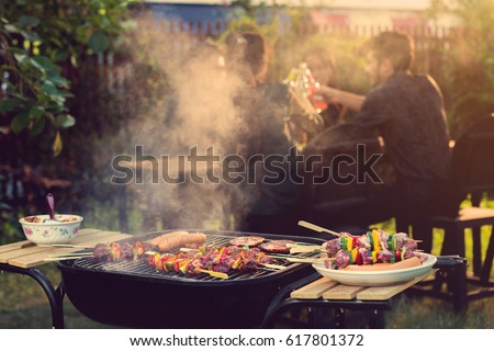 Dinner party, barbecue and roast pork at night
 Royalty-Free Stock Photo #617801372