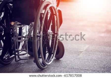 Close-up Empty wheelchair in front of the Outpatient Department of Hospital with sunlight Royalty-Free Stock Photo #617817008