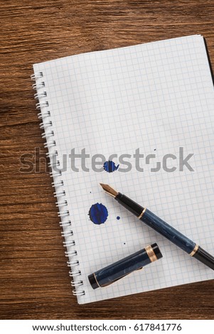Notepad with a pen on the table