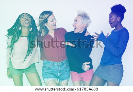 Women standing and posing for picture in funny style