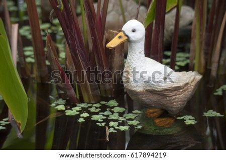 Duck statue in water