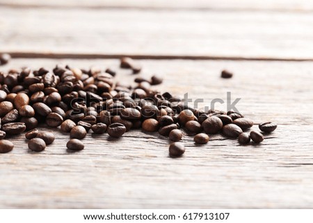 Roasted coffee beans on a grey wooden table