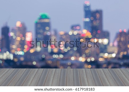 Opening wooden floor, City blurred bokeh light business downtown, abstract background