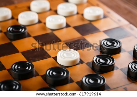checkerboard with checkers. Game concept. Board game. Hobby. checkers on the playing field for a game. Royalty-Free Stock Photo #617919614