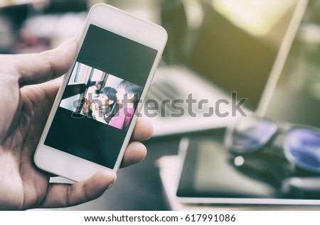 Business man is looking at family picture for motivation