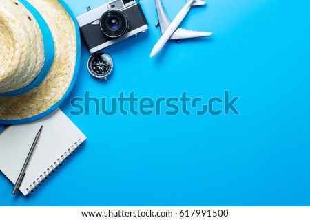 Summer Travel accessories and objects on blue background copy space, For Beach Vacation Journey with plane camera notebook, For Travel poster and banner advertisement Royalty-Free Stock Photo #617991500