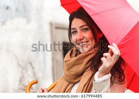 Portrait of beautiful woman with red umbrella