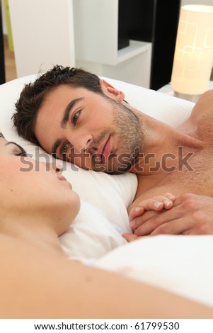 Man laid near a sleeping woman