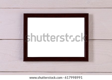 Blank brown wooden photography frame at grunge white background of wood with isolated template for the inside of the photo