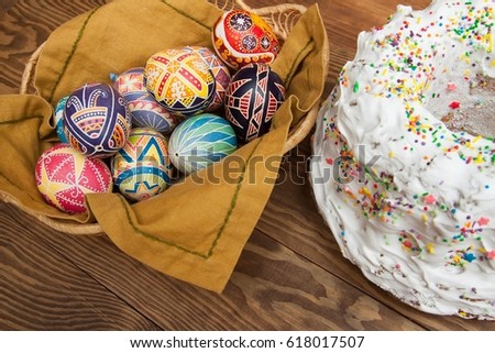 Colorful Happy Easter baking background. Blank, greeting easter card with handmade easter eggs and Easter cake in wooden background.
