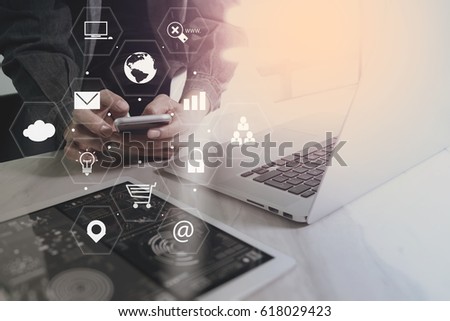 businessman working with mobile phone and laptop computer on wooden desk ,Social distancing and Working from home concept with virtual icons interface